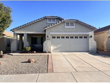 Charming single-story home featuring a two-car garage, low maintenance desert landscaping, and a well maintained exterior at 17225 W Carmen Dr, Surprise, AZ 85388