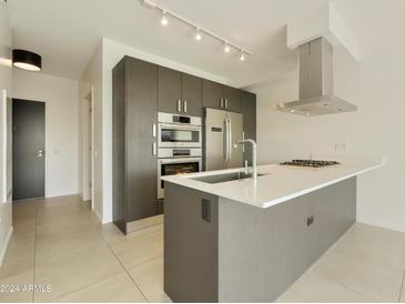 Modern kitchen featuring stainless steel appliances, gas cooktop, and a sleek, minimalist design at 7120 E Kierland Blvd # 316, Scottsdale, AZ 85254