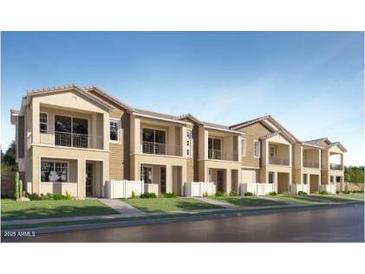 Attractive townhouse-style homes with a combination of light tan and dark tan finishes and a modern architectural design at 8149 E Petunia Ave # 1060, Mesa, AZ 85212