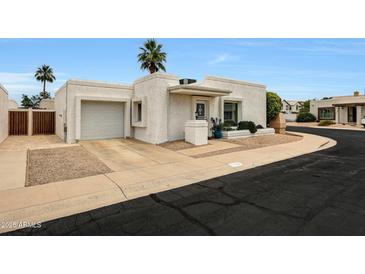 Inviting single-story home with a two-car garage, desert landscaping, and charming curb appeal at 1122 E Michelle Dr, Phoenix, AZ 85022