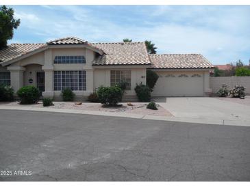 Charming single-story home features a two-car garage, desert landscaping, and a tile roof at 1333 N Higley Rd # 7, Mesa, AZ 85205