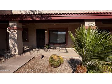 Inviting front porch with desert landscaping and seating area, perfect for relaxing at 1440 N Idaho Rd # 1022, Apache Junction, AZ 85119
