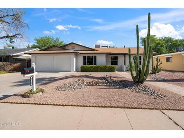 Charming single-story home featuring a two-car garage and a low-maintenance desert-style yard at 1713 W Royal Palm Rd, Phoenix, AZ 85021