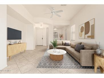 Bright living room with neutral decor, comfortable seating, and modern ceiling fan at 1887 W Periwinkle Way, Chandler, AZ 85248