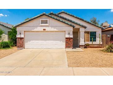 Charming single-story home with a two-car garage, low maintenance landscaping, and beautiful Southwestern design at 3006 W Matthew Dr, Phoenix, AZ 85027