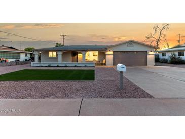 Charming single-story home featuring a quaint porch and a well-maintained front yard at 434 N 56Th St, Mesa, AZ 85205