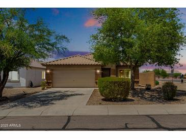 Inviting single-Gathering home featuring a two-car garage, desert landscaping, and a neutral color scheme at 5320 E Silverbell Rd, San Tan Valley, AZ 85143