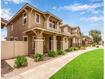 Inviting two-story home showcasing a well-manicured lawn and charming front porch in a sidewalk neighborhood at 5840 E Holmes Ave, Mesa, AZ 85206