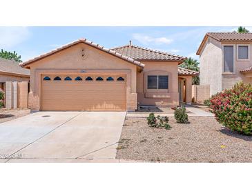 Charming single-story home with a well-manicured lawn and a two-car garage in a friendly neighborhood at 684 E Redondo Dr, Gilbert, AZ 85296