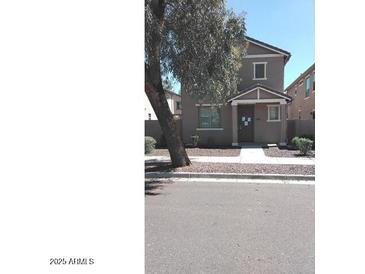 Charming two-story home with neutral-toned exterior and well-maintained landscaping at 7325 W Wilshire Dr, Phoenix, AZ 85035
