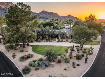 Stunning property boasts lush landscaping and mountain views, creating a serene and picturesque setting at 8022 N Ironwood Dr, Paradise Valley, AZ 85253