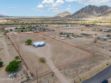 Spacious desert property with a house, clearly marked boundaries, and mountain views at 11192 N Johnson Rd, Maricopa, AZ 85139