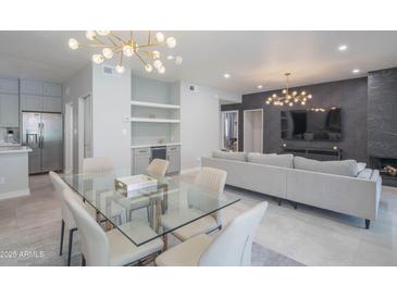 Bright and spacious living room featuring a modern light fixture and glass dining table at 11333 N 92Nd St # 1075, Scottsdale, AZ 85260