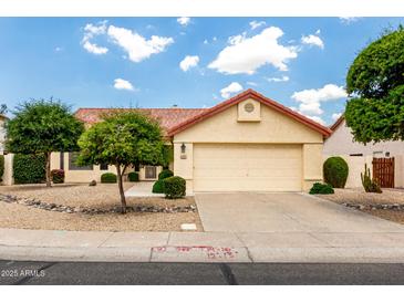 Charming home featuring a two-car garage and a well-maintained front yard with desert landscaping at 11524 W Rosewood Dr, Avondale, AZ 85392