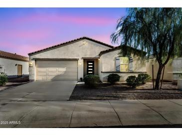 Charming single-story home featuring a neutral color scheme, low maintenance landscaping, and attached two car garage at 1747 E Grove St, Phoenix, AZ 85040