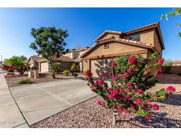 Charming home featuring a low-maintenance landscape and a two-car garage at 181 N 222Nd Dr, Buckeye, AZ 85326