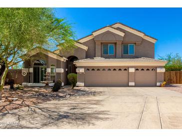 Stunning two-story home featuring a spacious three-car garage and beautifully landscaped front yard at 4801 E Quien Sabe Way, Cave Creek, AZ 85331