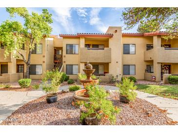 Attractive building exterior with mature landscaping and a decorative water feature at 7008 E Gold Dust Ave # 236, Scottsdale, AZ 85253