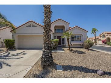 Charming single-Gathering home with desert landscaping, two car garage and decorative architectural features at 823 W Bradford Dr, Gilbert, AZ 85233
