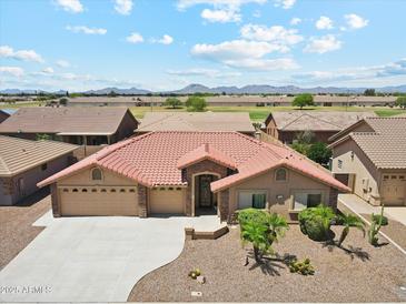 Beautiful single-story home featuring a three car garage, low maintenance landscaping, and a tile roof at 11320 E Newcastle Ave, Mesa, AZ 85209
