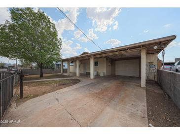 Charming single-story home featuring a covered parking area and well-maintained front yard at 1614 S 6Th Ave, Phoenix, AZ 85003
