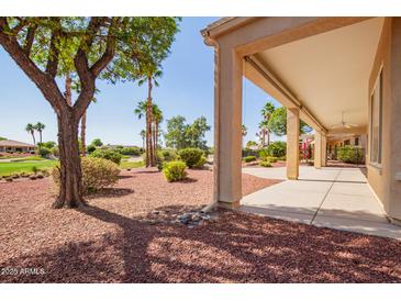 Relaxing covered back patio overlooking a beautifully landscaped yard and golf course view at 22222 N Pedregosa Dr, Sun City West, AZ 85375