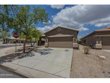 Single story home with a two car garage, low maintenance landscaping, and a concrete driveway at 29058 N Cactus Cir, San Tan Valley, AZ 85143