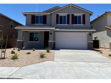 Beautiful two-story home featuring a well-manicured front yard and two-car garage at 31866 N Bandit Rd, San Tan Valley, AZ 85143