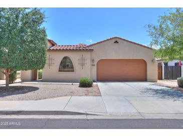 Charming single-story home with a red tile roof, neutral stucco, and a spacious two-car garage at 36255 W Marin Ave, Maricopa, AZ 85138