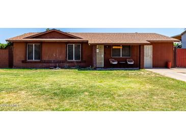 Charming single-story home with a well-maintained lawn and covered front porch at 3723 W Columbine Dr, Phoenix, AZ 85029