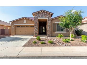 Charming single-story home featuring a stone facade, desert landscaping, and a two car garage at 3894 E Dogwood Pl, Chandler, AZ 85286