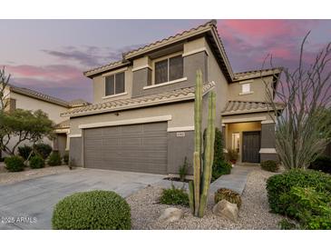 Charming two-story home with a desert landscaped front yard, attached two car garage and a tile roof at 40807 N Barnum Way, Anthem, AZ 85086