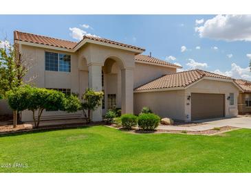 Spacious two-story home featuring a landscaped yard, archway entrance, and a two-car garage at 453 E Baylor Ln, Gilbert, AZ 85296