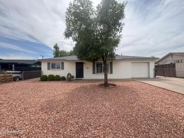 Charming single-story home with well-maintained landscaping and a two-car garage at 4602 N 50Th Ave, Phoenix, AZ 85031