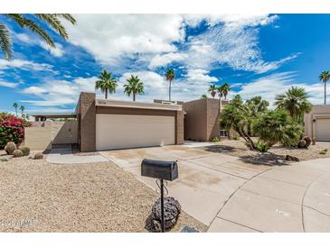 Charming home featuring desert landscaping, palm trees, and a two-car garage in a sunny neighborhood at 5526 N 77Th Way, Scottsdale, AZ 85250