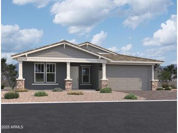 Charming single-story home features a two-car garage, stone accents, and a welcoming front entrance at 5610 W Hopi Trl, Laveen, AZ 85339