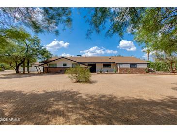 Charming single-story home featuring desert landscaping, a well-maintained exterior and a welcoming facade at 7102 E Kalil Dr, Scottsdale, AZ 85254