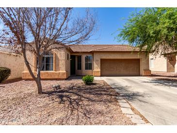 Charming single-story home featuring low maintenance desert landscaping and a two car garage at 1130 E Ferrara St, San Tan Valley, AZ 85140
