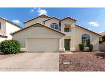 Charming two-story home with a two-car garage, well-maintained landscaping, and inviting curb appeal at 1421 E Charleston Ave, Phoenix, AZ 85022