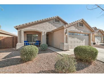 Charming single-story home with a well-maintained front yard and a cozy front porch with seating at 15453 W Shangri La Rd, Surprise, AZ 85379