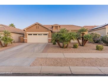 Charming single-Gathering home with a two-car garage and beautifully landscaped front yard at 16375 W Cortez St, Surprise, AZ 85388