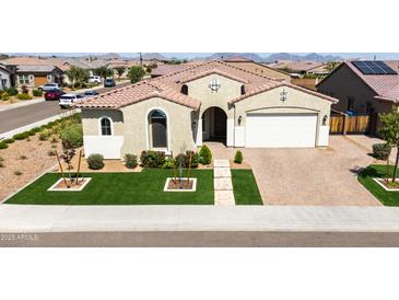 Charming single-story home featuring a tile roof, green lawn, and inviting front entrance with decorative shrubbery at 22721 N 34Th St, Phoenix, AZ 85050