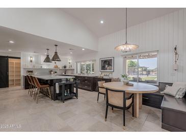 Open kitchen featuring a large island, modern appliances, and a dining area with comfortable seating at 2724 W Colt Rd, Chandler, AZ 85224