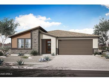 A charming single-story home featuring a two-car garage, stone accents, and desert landscaping at 28909 N 172Nd Dr, Surprise, AZ 85387