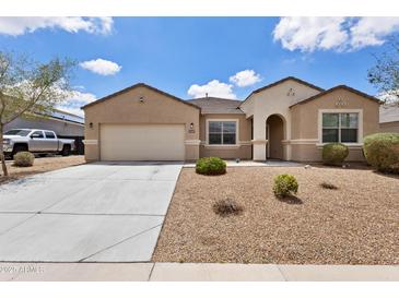 Charming single-story home with a two car garage, low maintenance landscaping and desert style yard at 3529 N Brooklyn Dr, Buckeye, AZ 85396