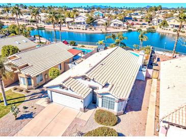Beautiful waterfront property with a private pool and well-manicured landscaping at 7140 E Juanita Ave, Mesa, AZ 85209