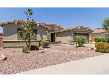 Single-story home boasting a desert landscape, attached garage, and neutral-toned exterior at 794 W Leatherwood Ave, Queen Creek, AZ 85140