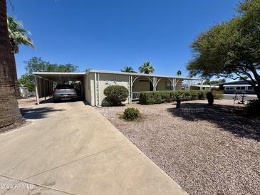 Single story home with covered parking, landscaped yard, and desert rock at 120 N Val Vista Dr # 272, Mesa, AZ 85213