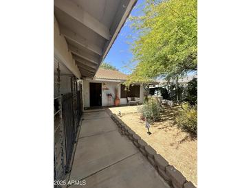 Charming front yard of this well-maintained home with mature landscaping and a cozy seating area at 14402 N Saguaro Blvd # A, Fountain Hills, AZ 85268