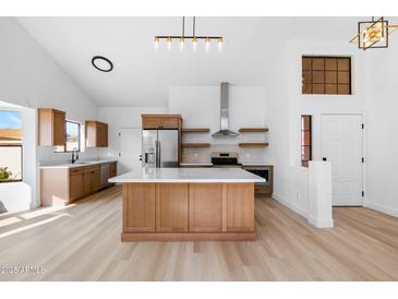 Bright and spacious kitchen with modern appliances, a central island, and light wood flooring at 14418 S 42Nd St, Phoenix, AZ 85044